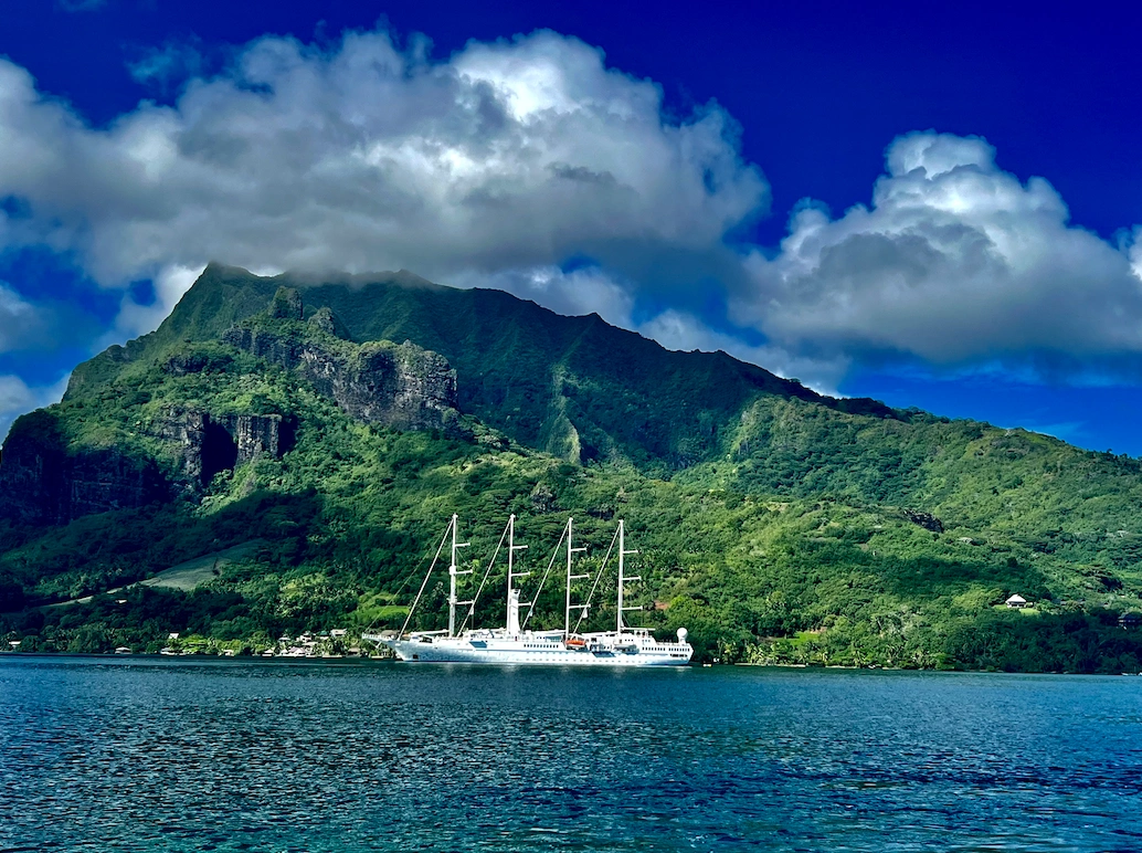 Small boutique sailing ship on clear blue water